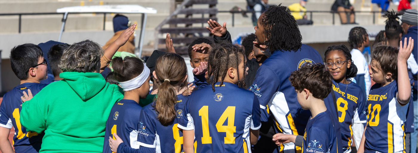 Soccer team in a huddle.