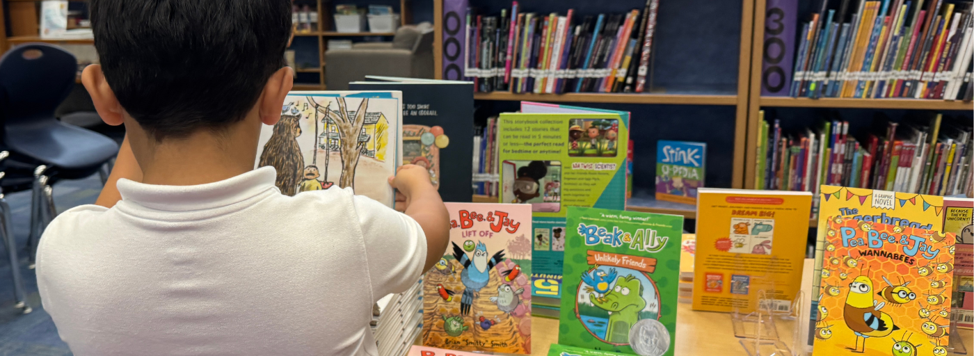 Student with an open book at the &#34;Free Book&#34; Fair.